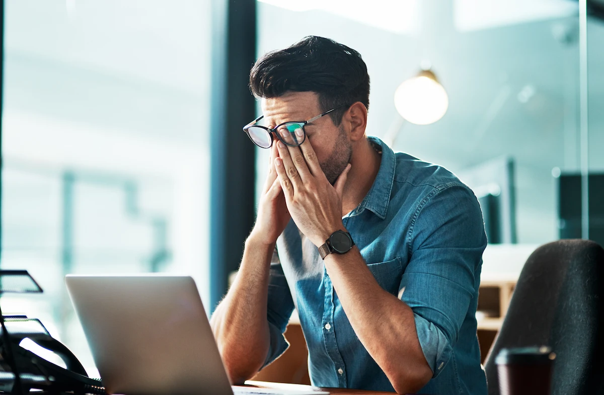stress_impacting_vision Stressed man rubbing his eyes